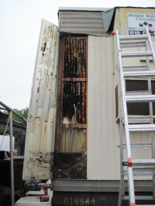 Large hive exposed in metal storage container. 